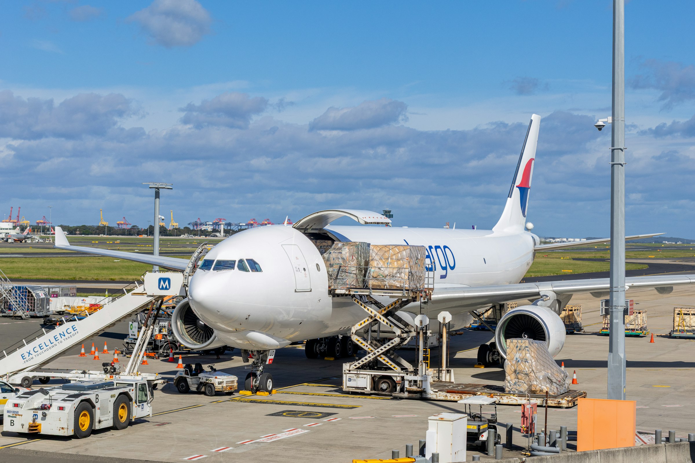 Cargo freighter aircraft being loaded on the tarmac